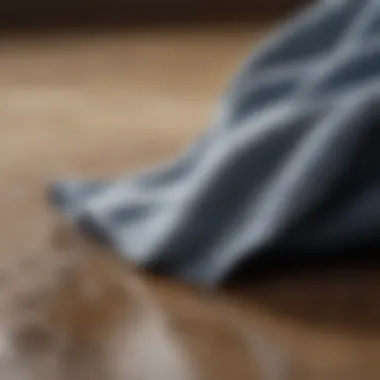 Microfiber Cloth: The Ultimate Dusting Companion Close-up of a microfiber cloth absorbing dirt and dust from a surface