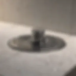 Close-up of a clean shower drain revealing its shiny surface