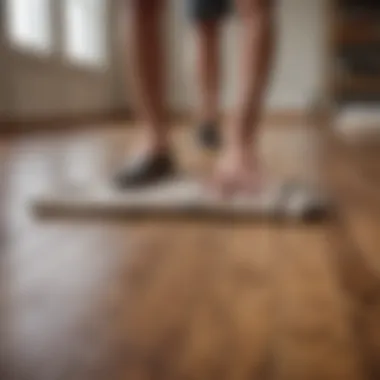 Cleaning Wood Floor with Cloth Person applying a cloth to clean a wood floor