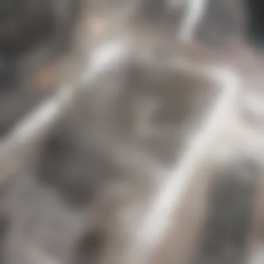 A person using a plunger on a bathtub drain