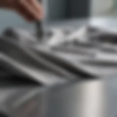 Effective Application Technique Close-up of a cloth being applied to a stainless steel surface, showcasing the cleaning action.